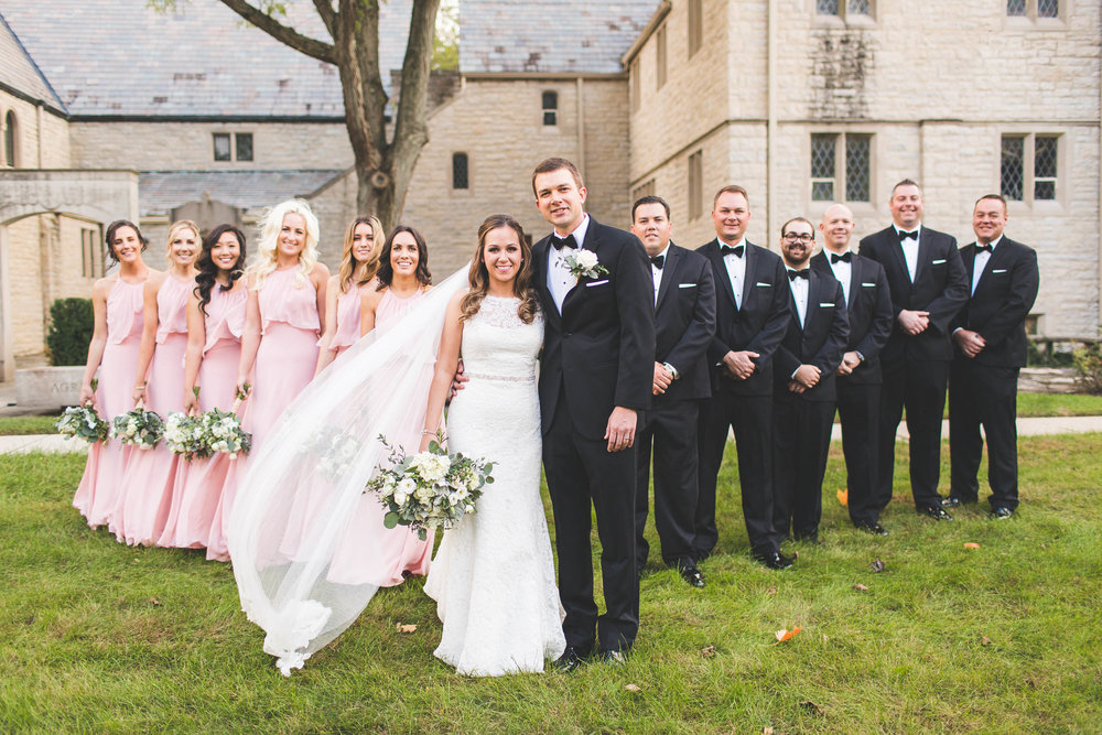 wedding party posing outside first community church on cloudy day