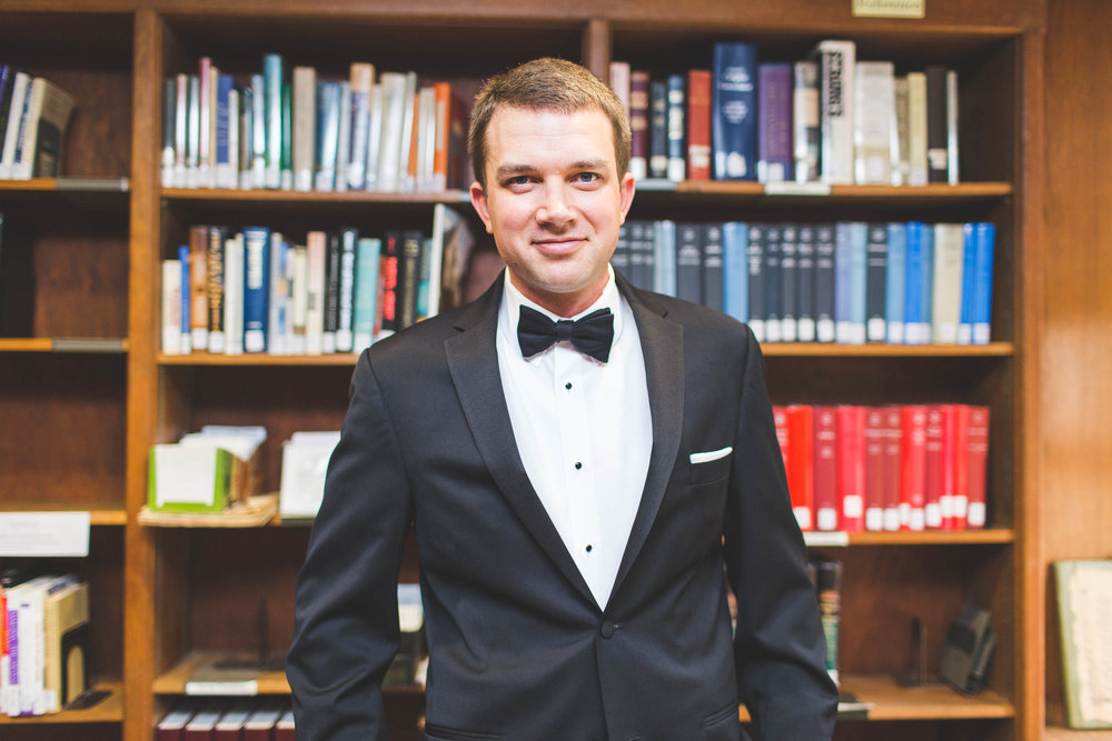groom in church library on wedding day