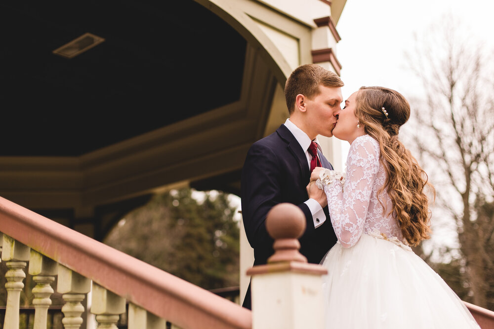 bride and groom kissing in gazebo during first look youngstown ohio wedding