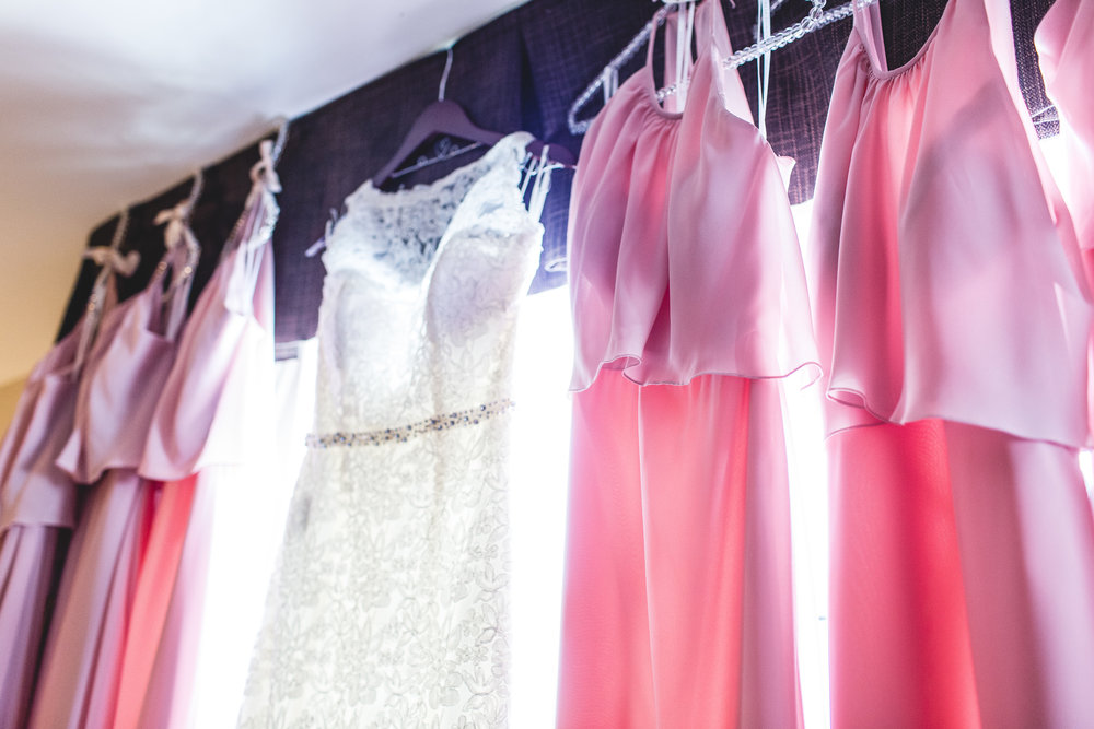 lacy bridal party dresses hanging in a window in columbus ohio