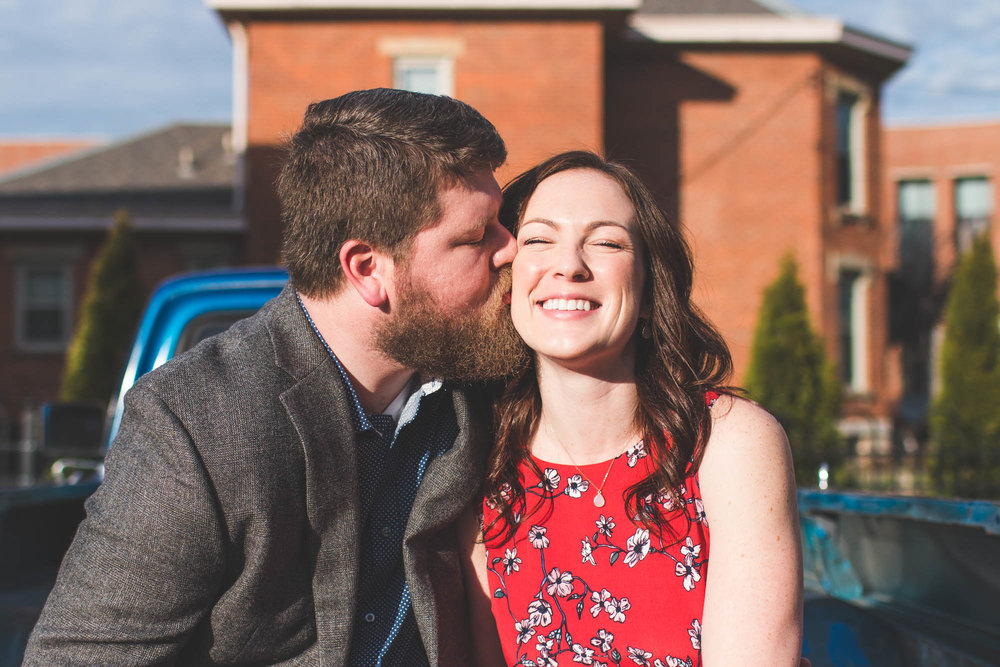 pickup truck engagement outside red floral dress