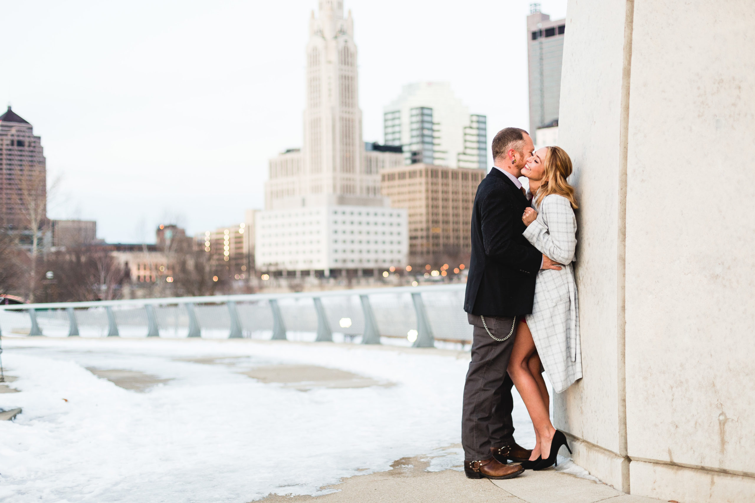 engaged couple kissing on broad street bridge in columbus ohio winter