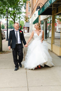 bride and groom walking down urban sidewalk wedding photography in circleville ohio