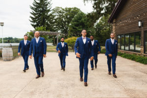 sam and grace photography winery wedding groomsmen walking
