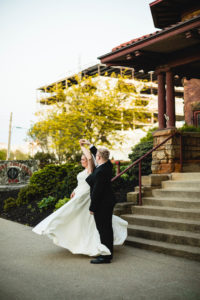 bride and groom dance as bride spins in front of historic train station in columbus ohio