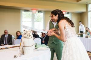 cutting wedding cake with machete