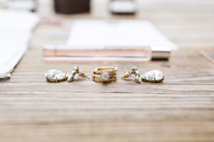 wedding rings and jewelry on a wooden bench