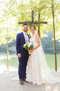 Bride and groom portrait in a forest with a lake