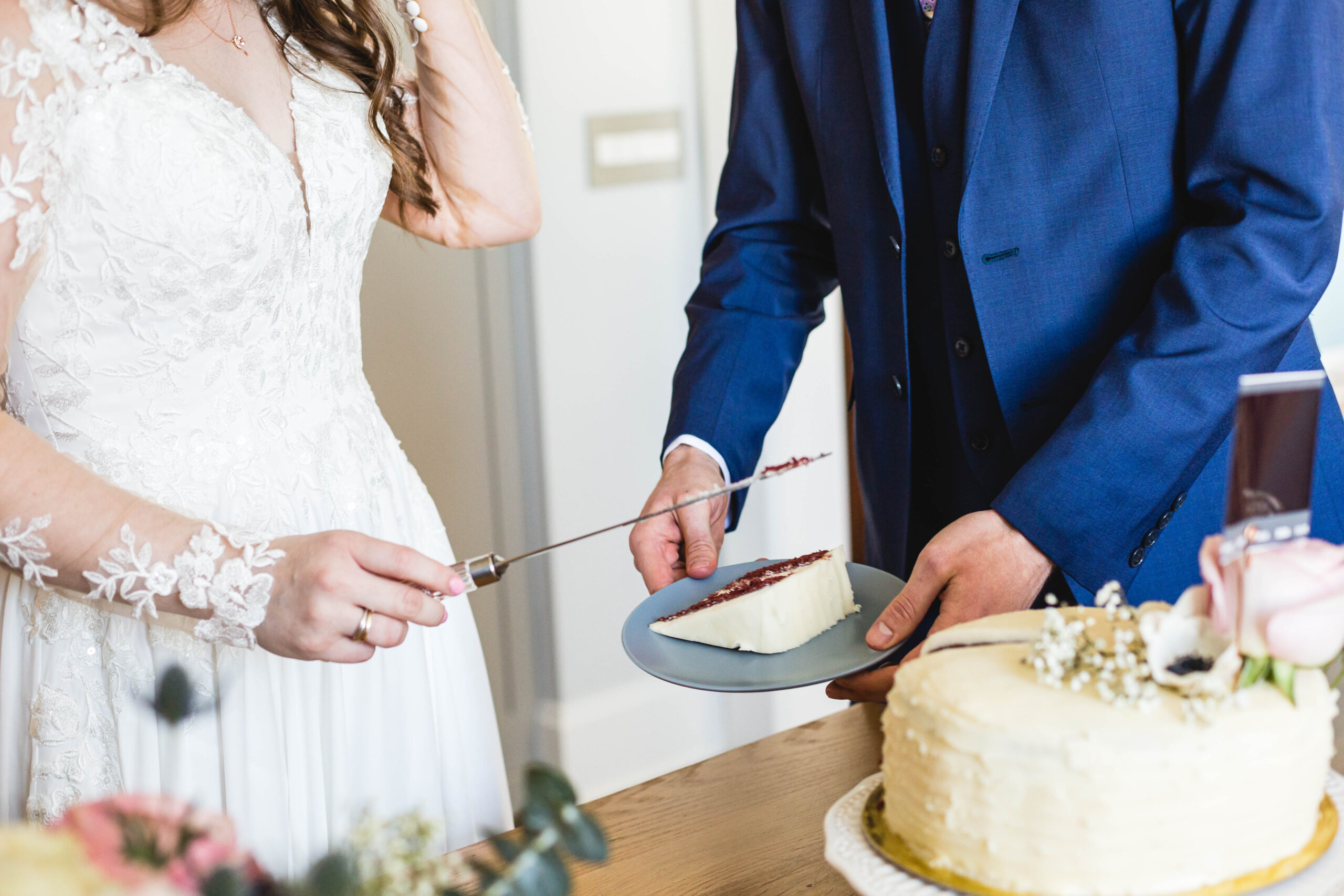 bride and groom cut red velvet cake during their elopement