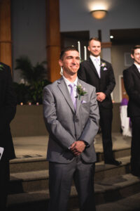 Groom crying when seeing his bride down the aisle in a church