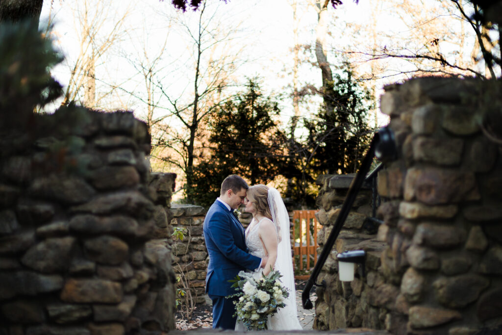 bride and groom embrace between castle walls ohio