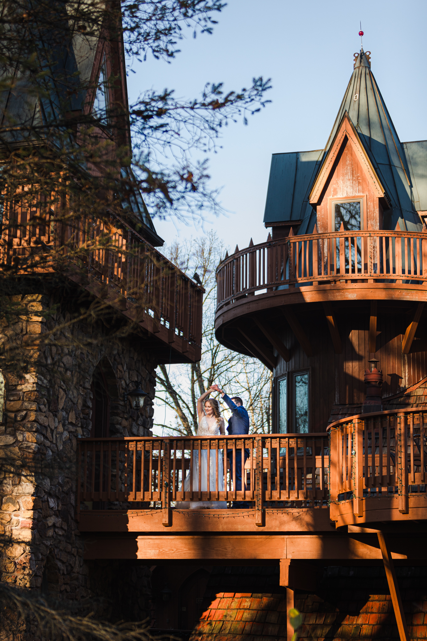 bride and groom dance on top of a castle