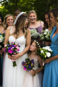 bride and flower girl share a moment