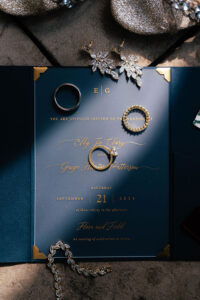 photo of blue wedding invitation with wedding rings at flora and field ohio