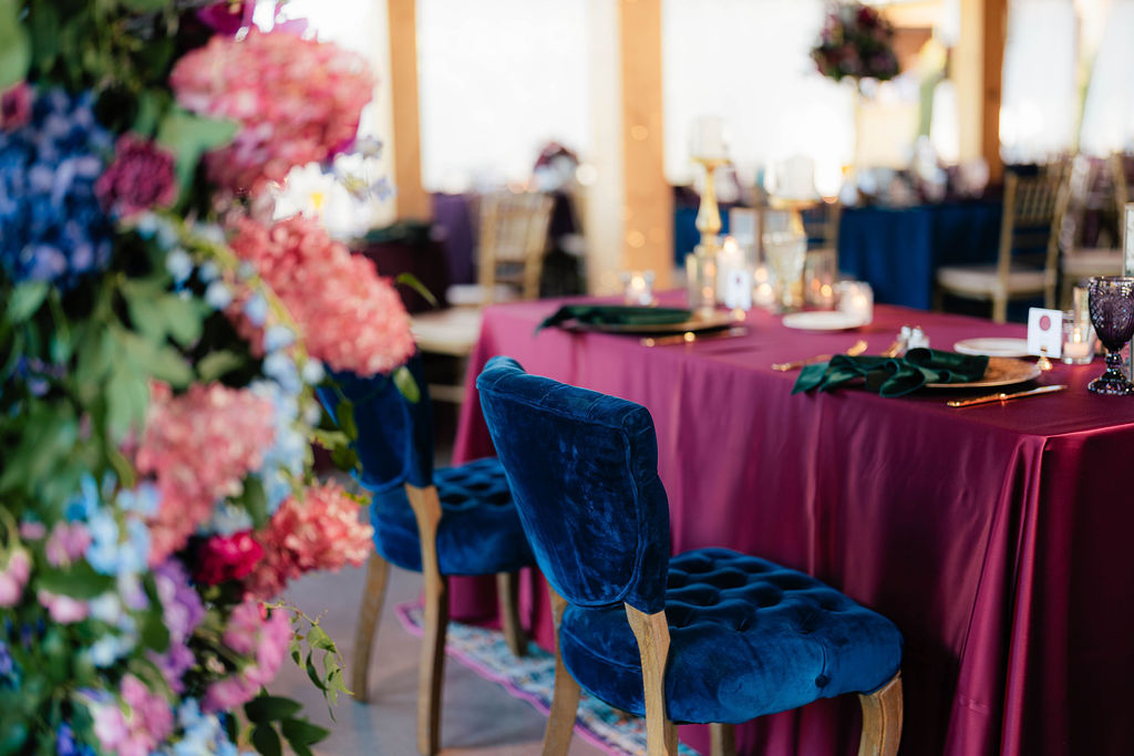 royal blue and magenta wedding decoration at luxurious flora and field barn wedding venue in ohio 