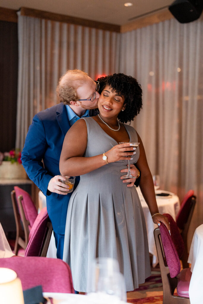 engaged couple snuggles at Butcher and Rose by sam and grace photography